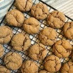 cooling rack full of baked molasses cookies