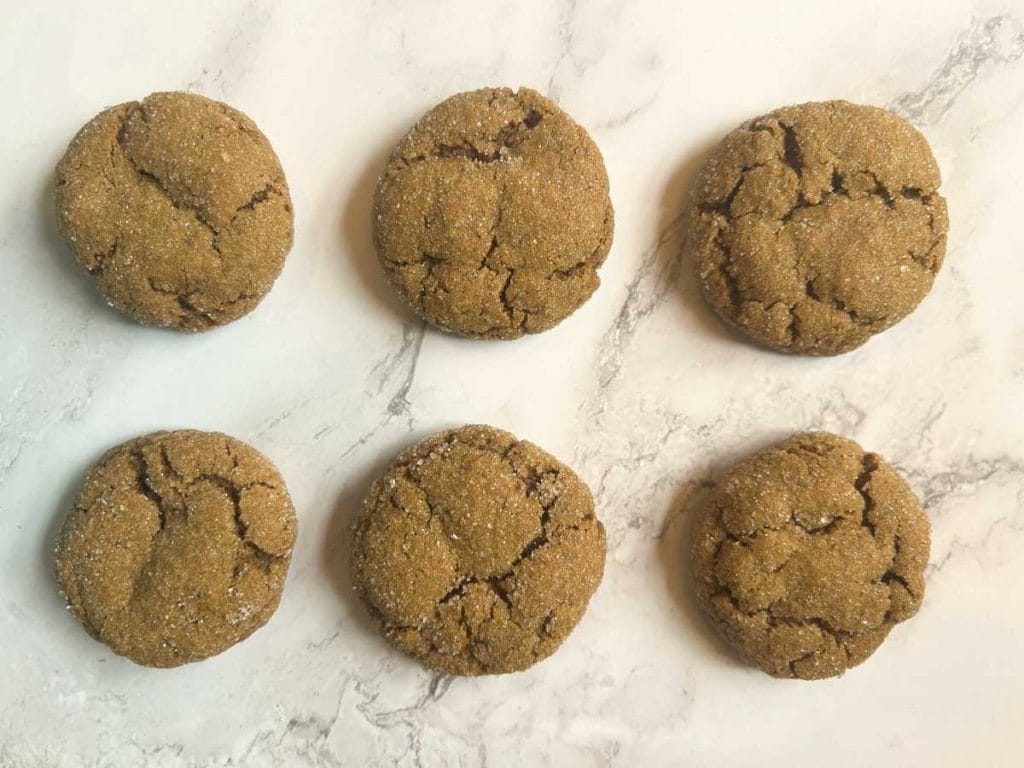 six sourdough molasses cookies arranged on a countertop