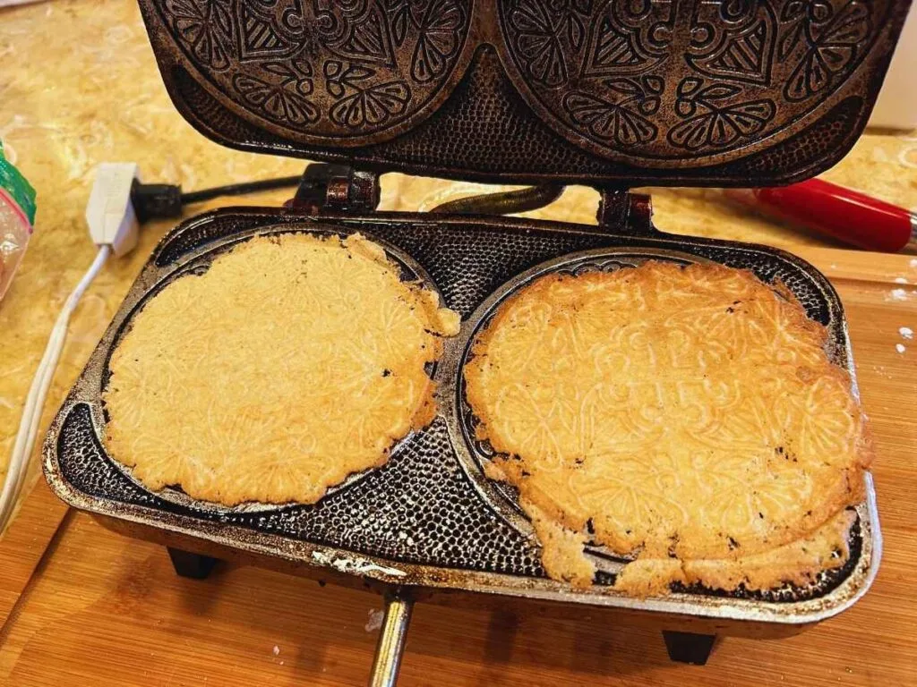 finished cookies on krumkake iron