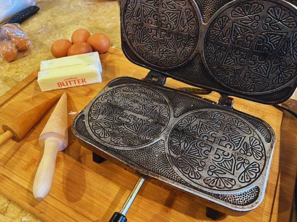 krumkake iron opened up next to ingredients