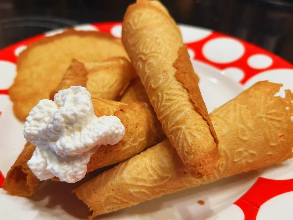 krumkake with whipped cream on a plate