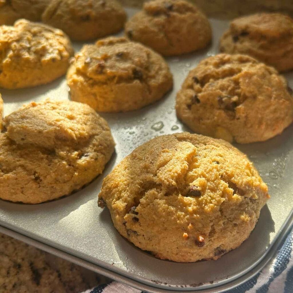 up close view of baked chocolate chip banana muffins in the tin
