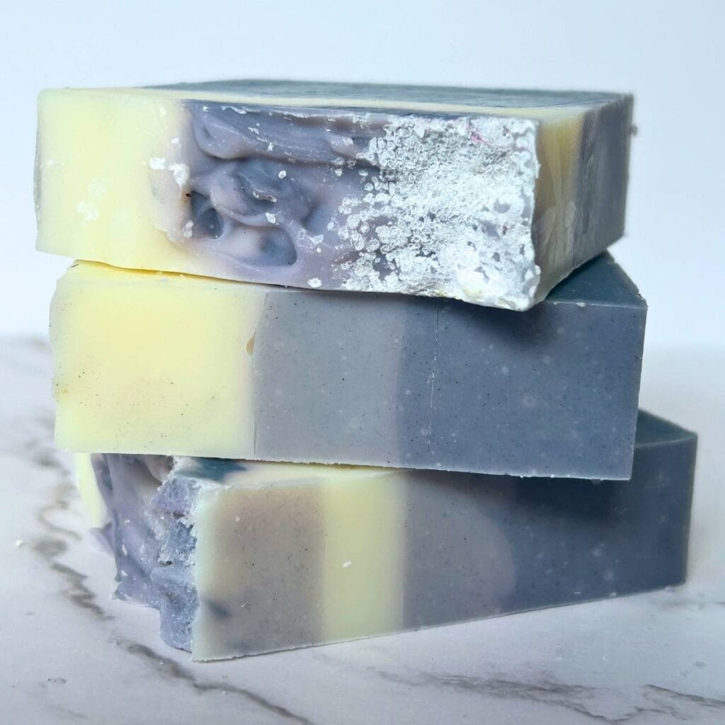 three bars of three layer blue eucalyptus mint tallow soap stacked up on their sides