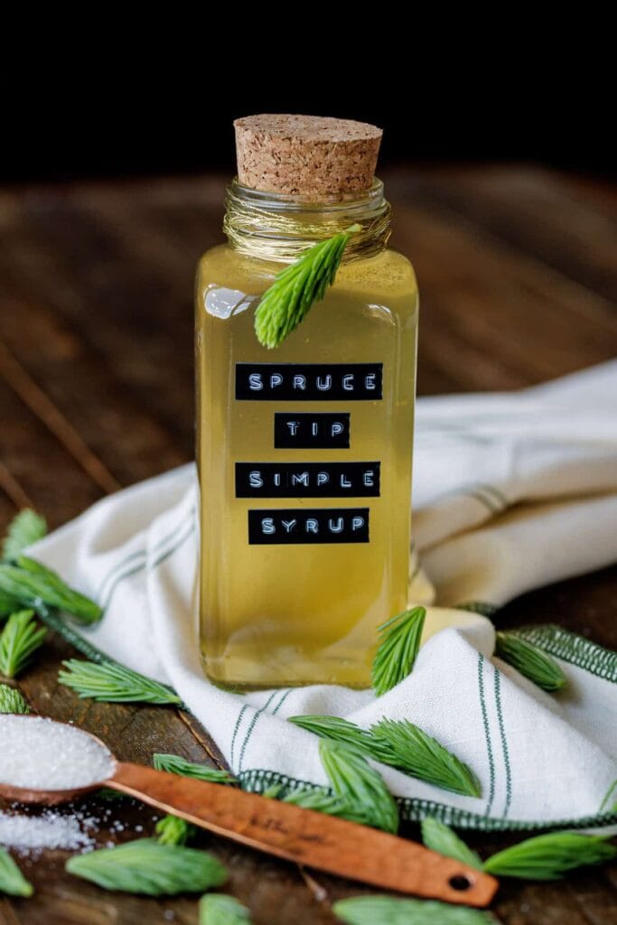 spruce tip simple syrup in glass bottle with label
