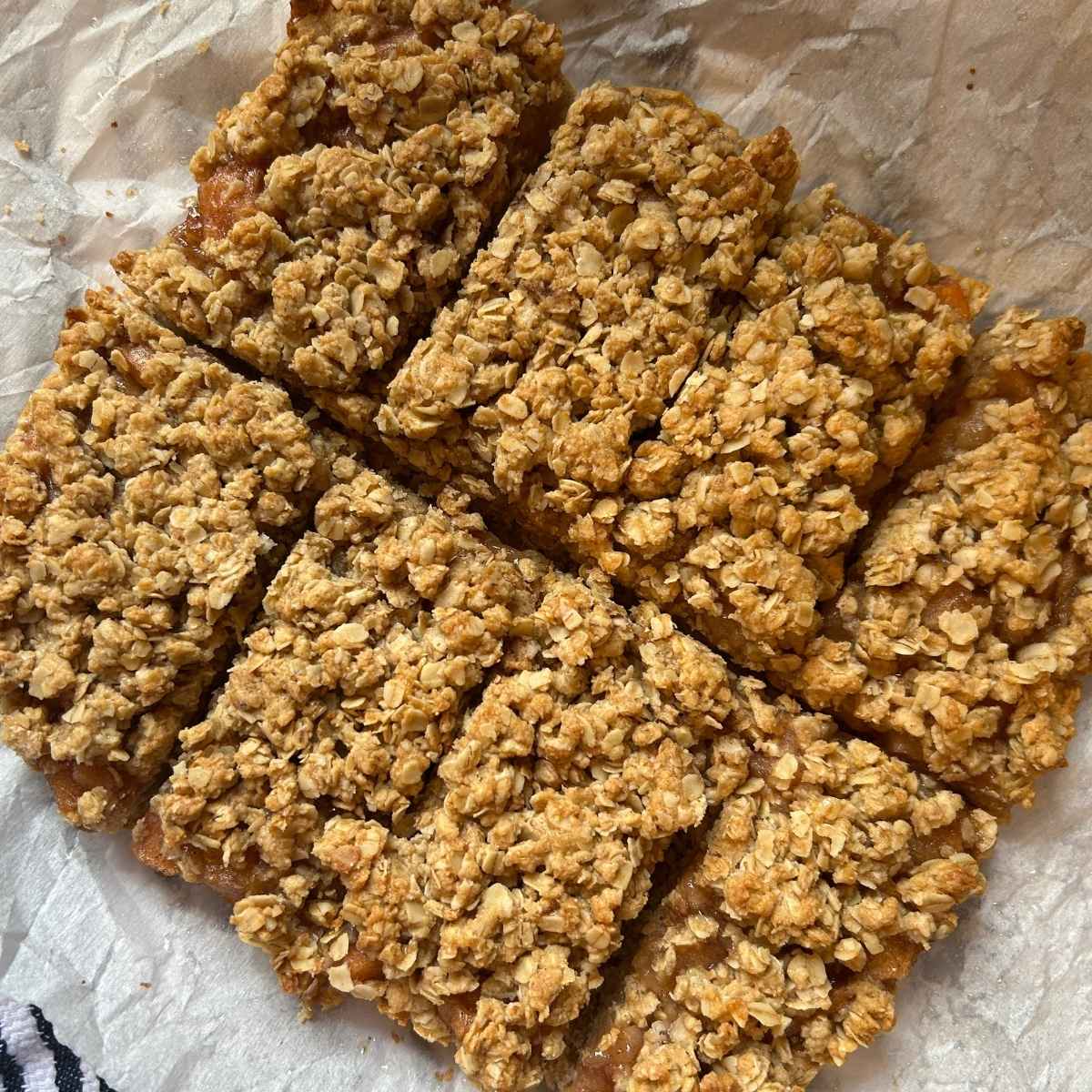8 slices of apple pie oat bars on parchment paper