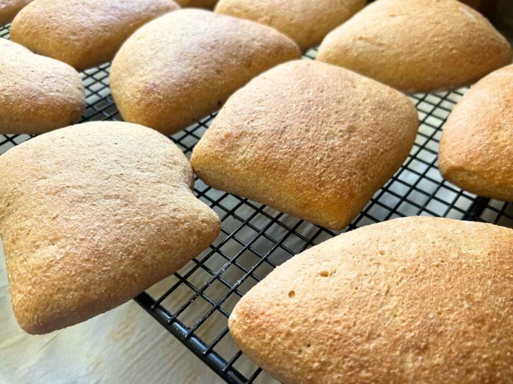 fresh milled ciabatta rolls cooling on a wire rack