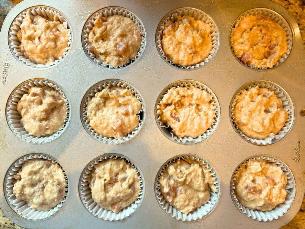 apple pie cupcake batter resting in muffin pan