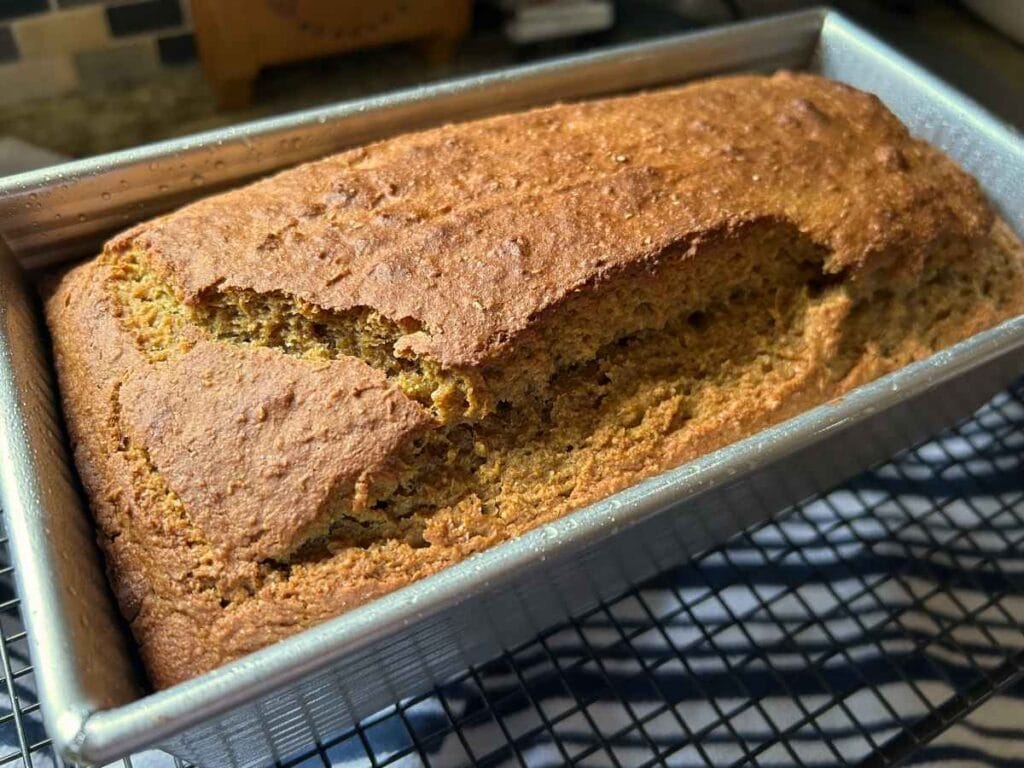 baked loaf of sourdough discard pumpkin bread in the pan
