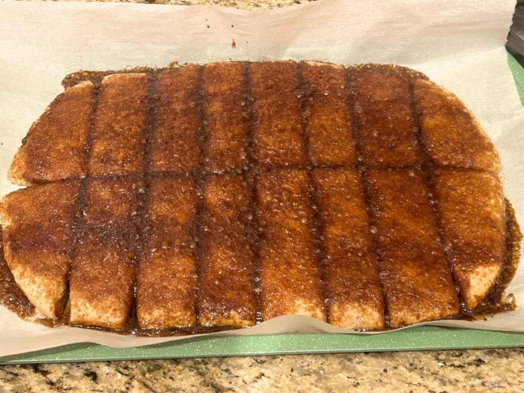 baked sourdough pumpkin cinnamon sticks on a baking pan
