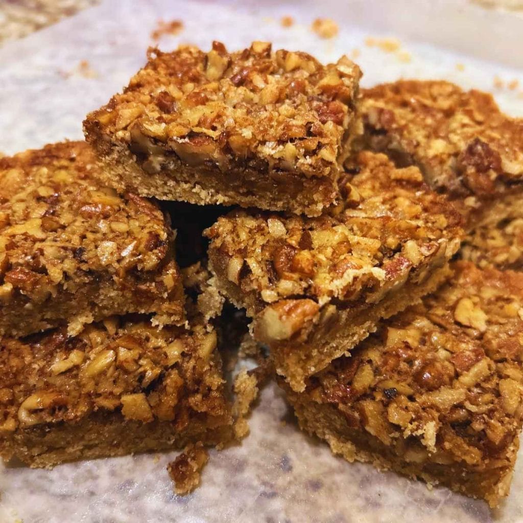 pecan pie bars stacked in a pile