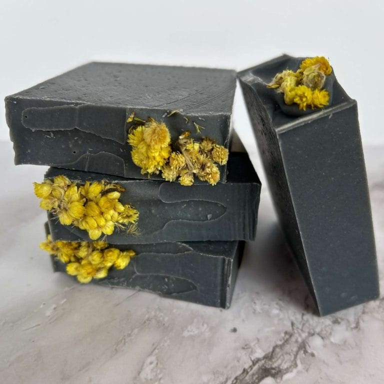 bars of charcoal and tea tree tallow soap stacked up