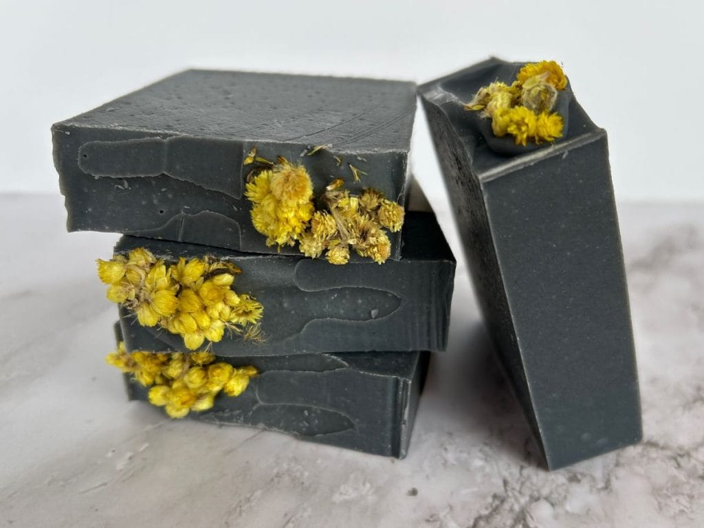 bars of charcoal and tea tree tallow soap stacked up