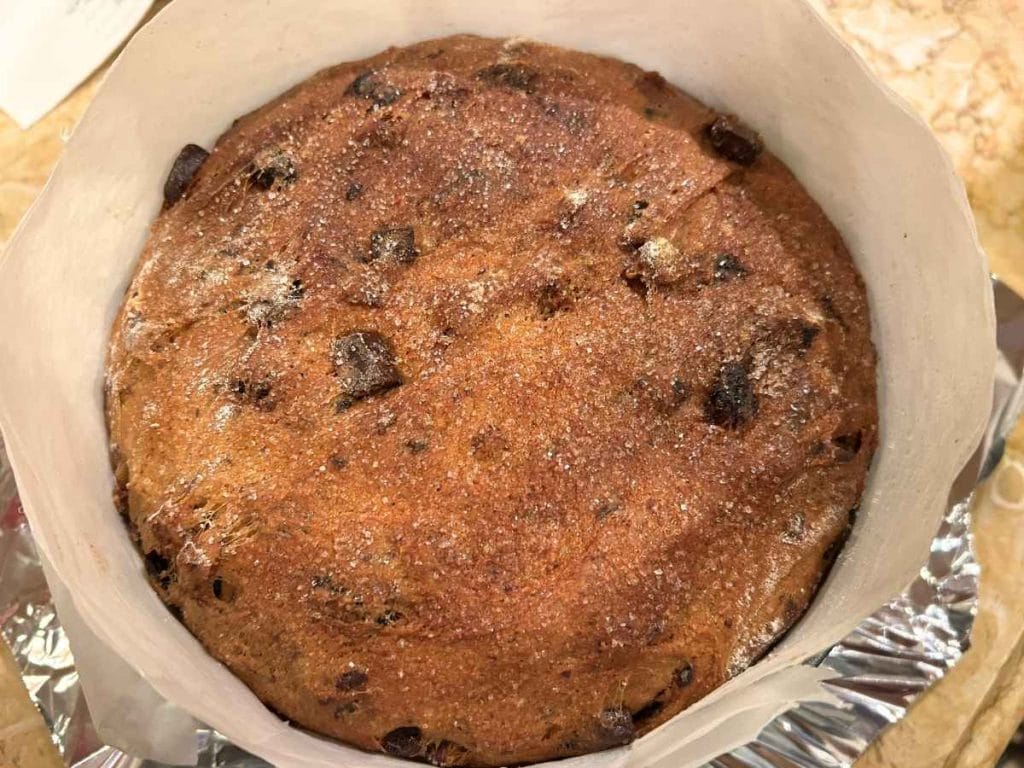 close up of the top of a baked cherry chocolate panettone loaf