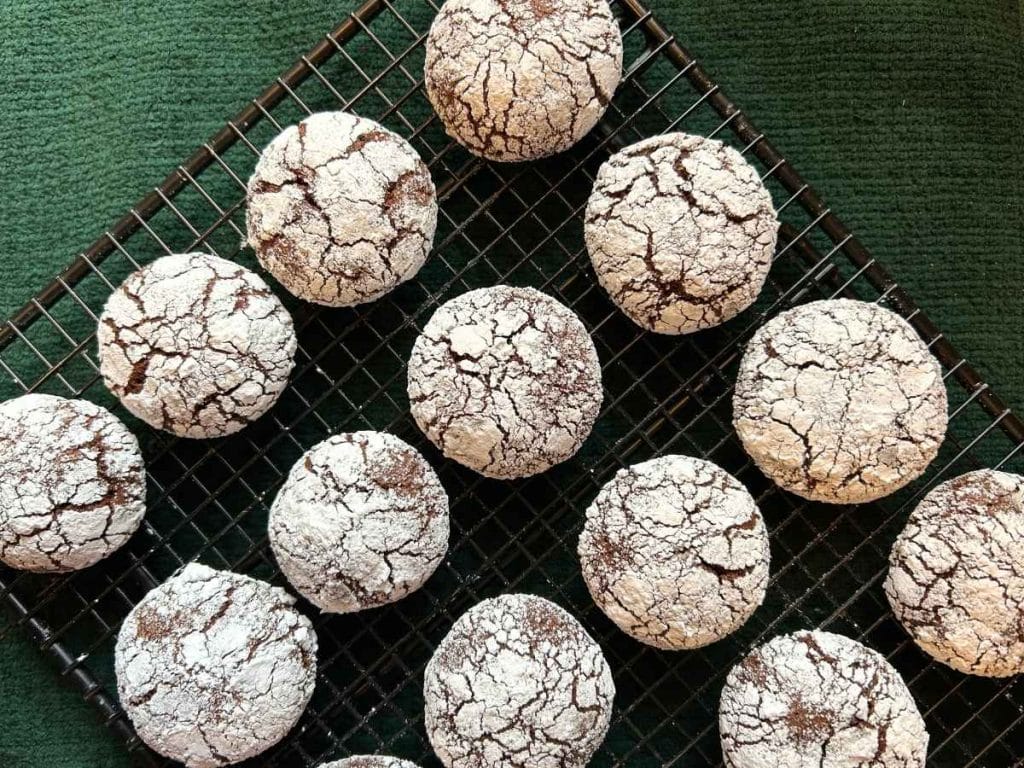 chocolate crinkle cookies cooling on a wire rack