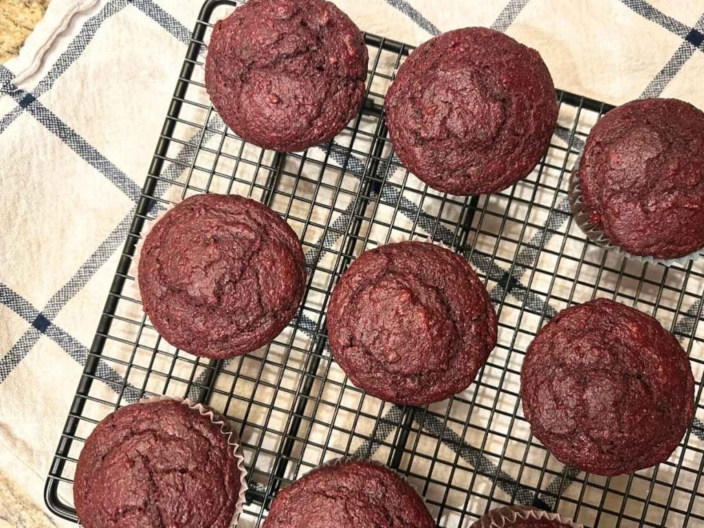 muffins on a cooling rack on top of a kitchen towel