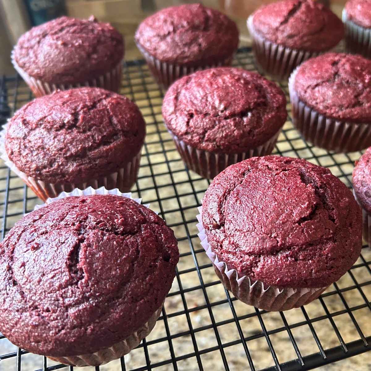 baked chocolate beet muffins on a cooling rack