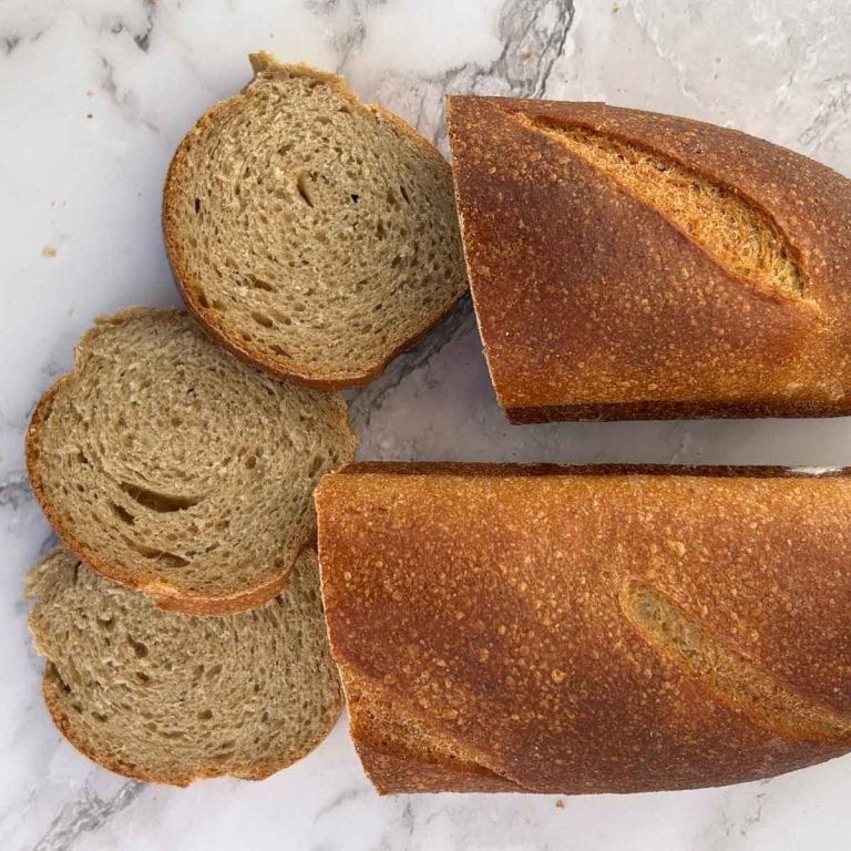 a loaf of sourdough french bread sliced in the middle and laid out