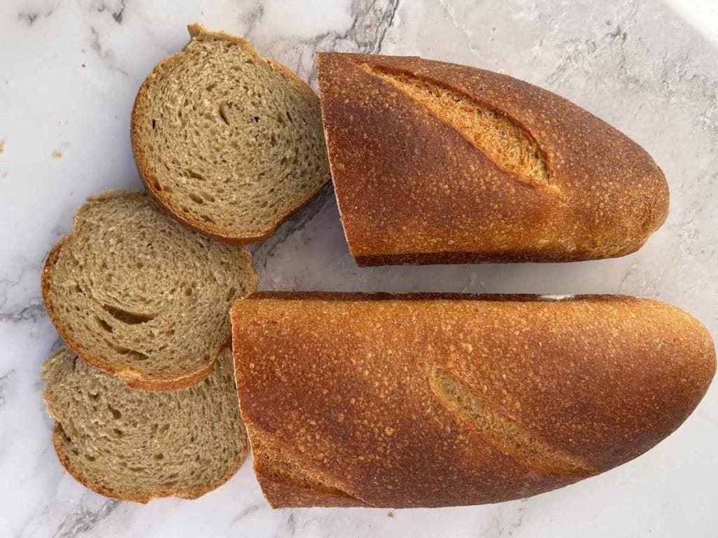 a loaf of sourdough french bread sliced in the middle and laid out