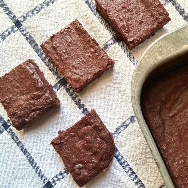 squares of beet brownies on a kitchen towel next to the pan