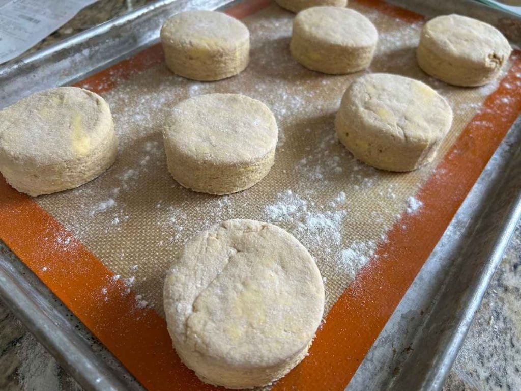 baking sheet with cut biscuits arranged before baking