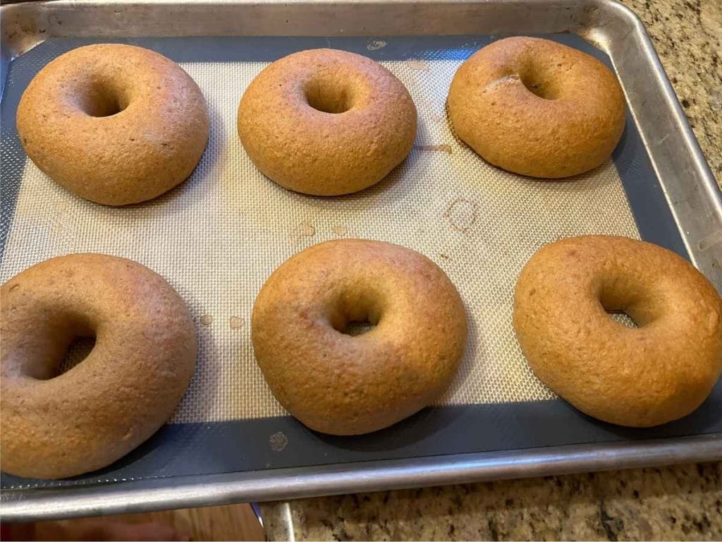 a pan of baked sourdough bagels