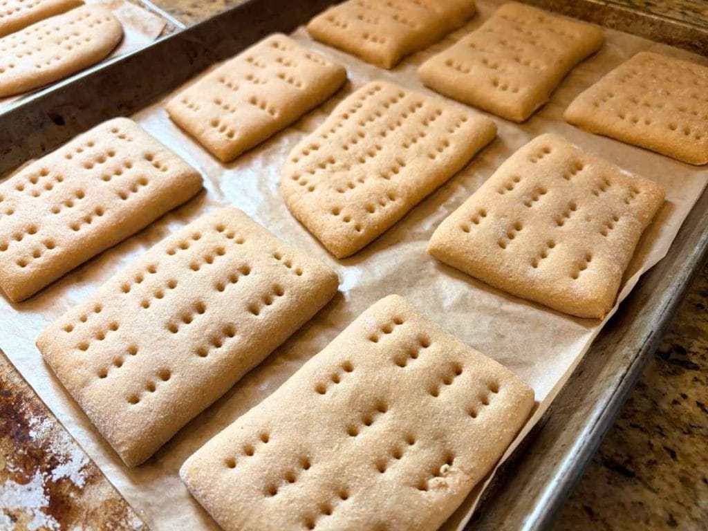 baked sandwich thins on a parchment-lined baking sheet