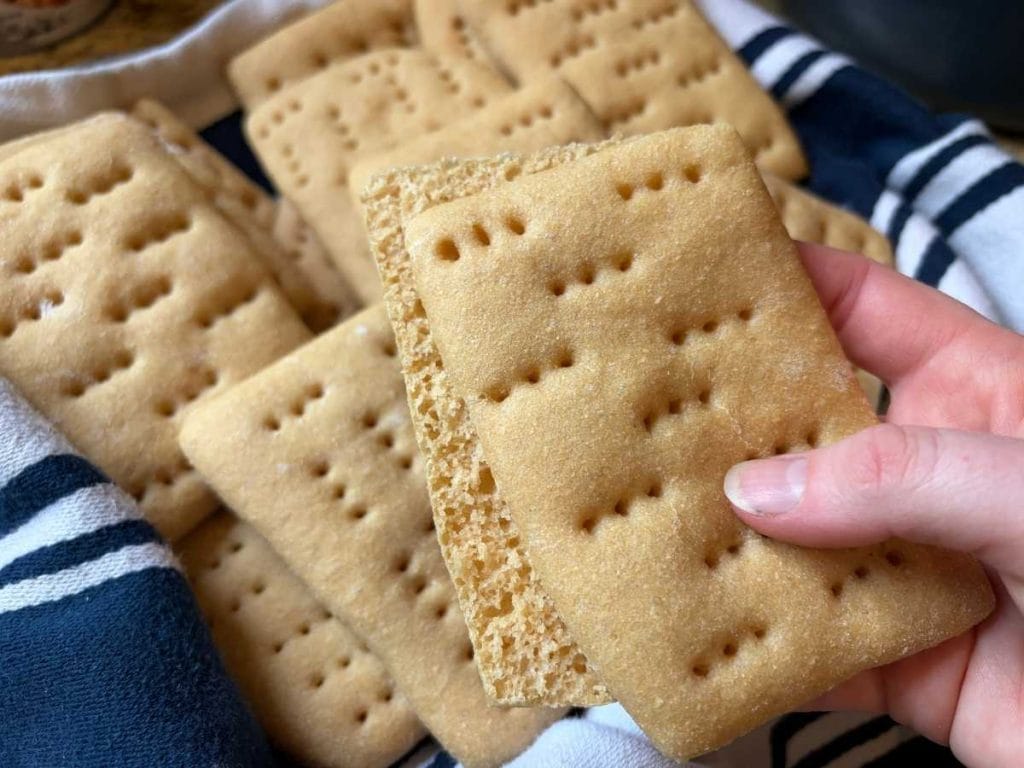 sandwich thins in a towel lined basket with one sliced in half to show middle