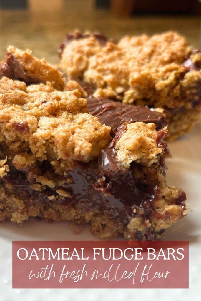 Oatmeal fudge bars made with fresh‑milled flour, sliced into squares and arranged on a plate with text overlay for pinterest