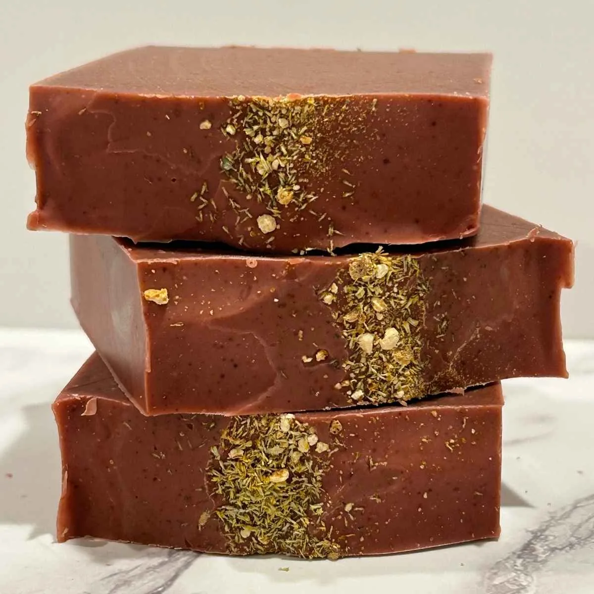 three bars of red citrus sorbet tallow soap stacked up