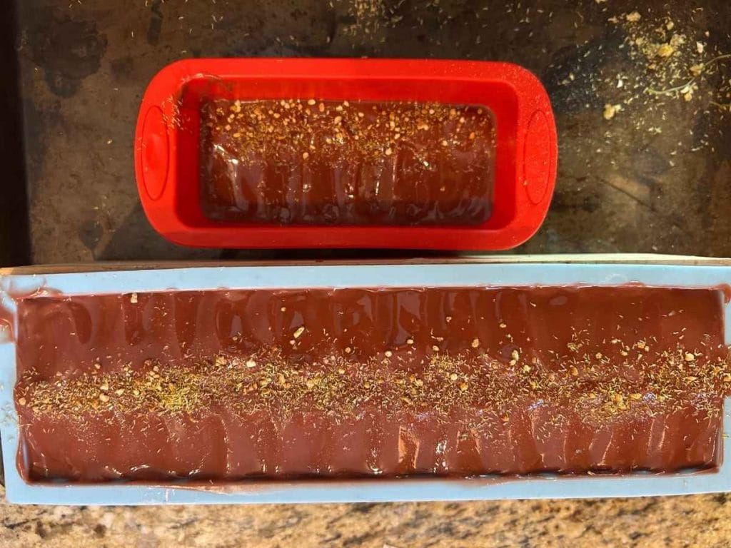 top view of a red soap poured into molds and decorated with flower dust before curing