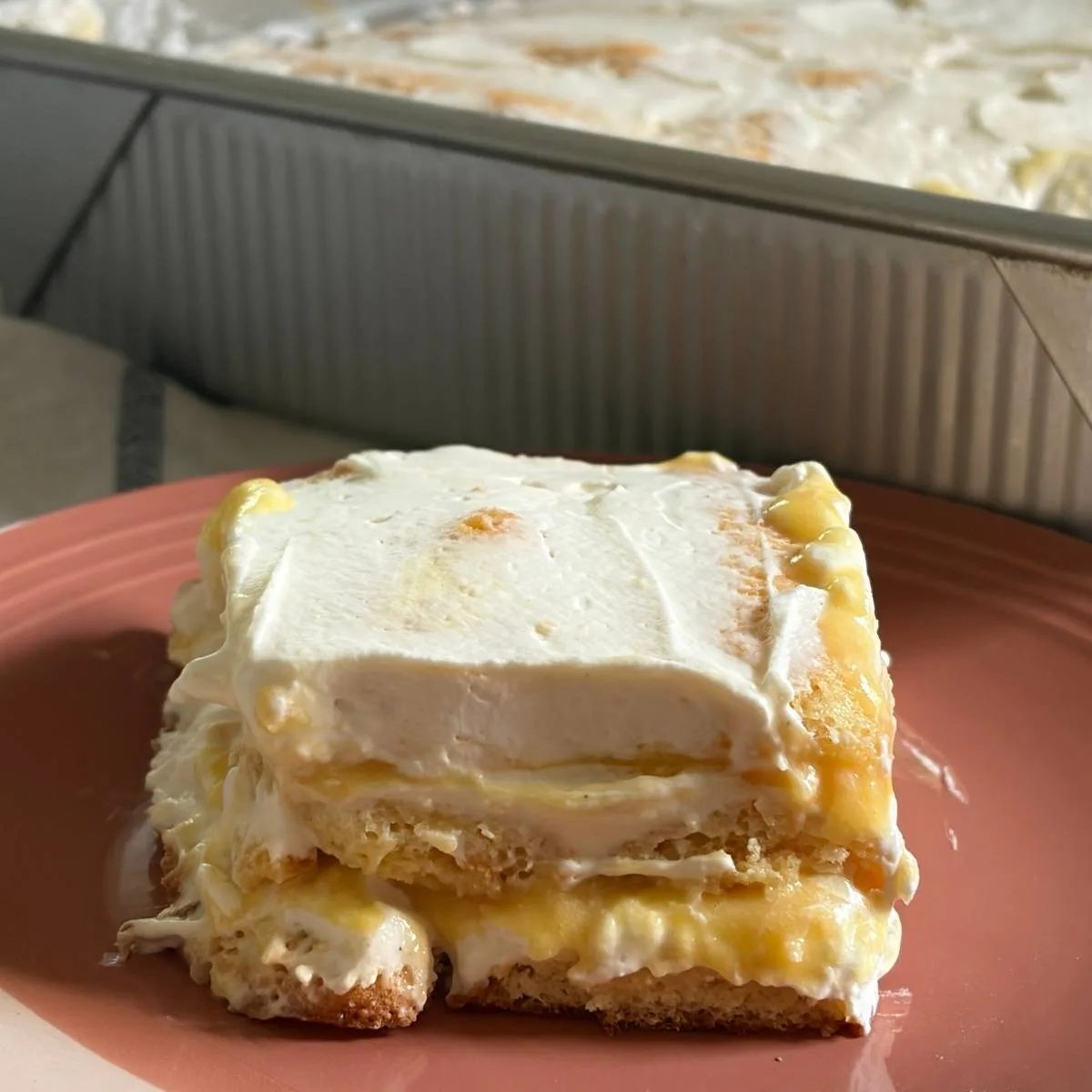 side view of a slice of peach tiramisu in front of the pan