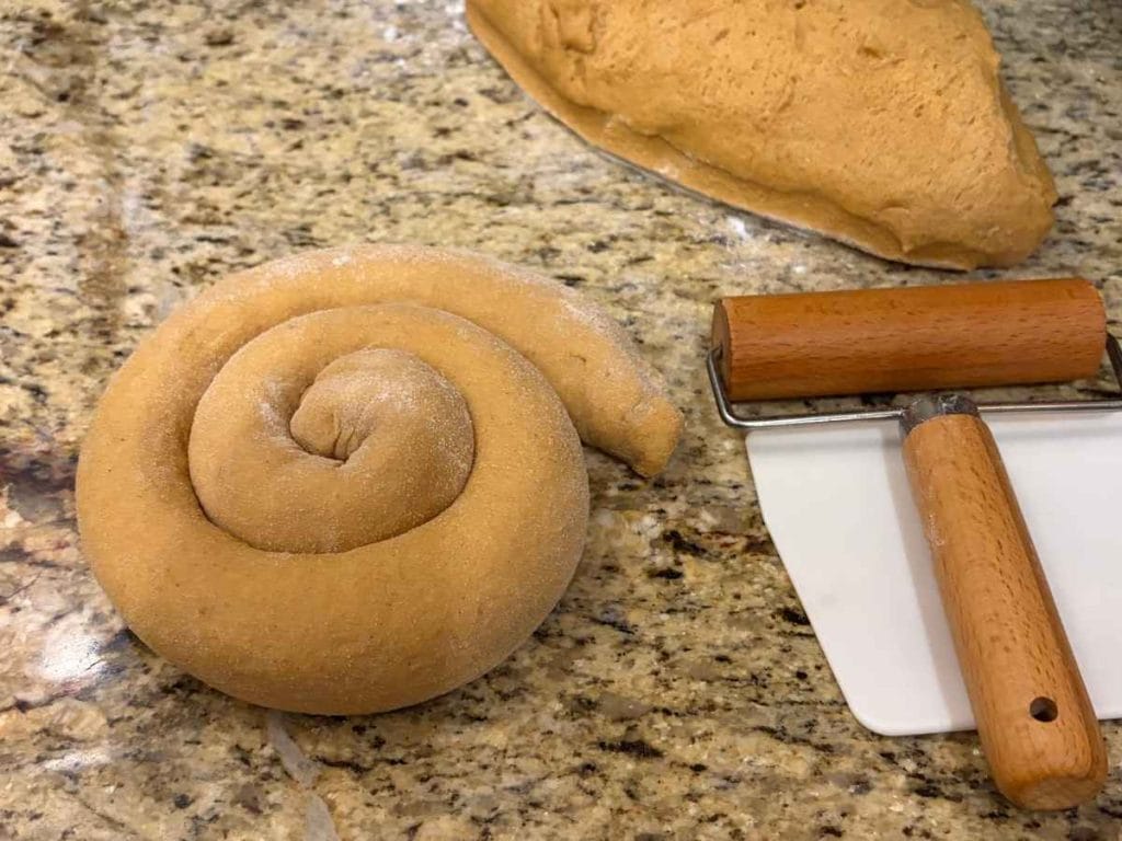 shaping bread dough into a spiral before rising