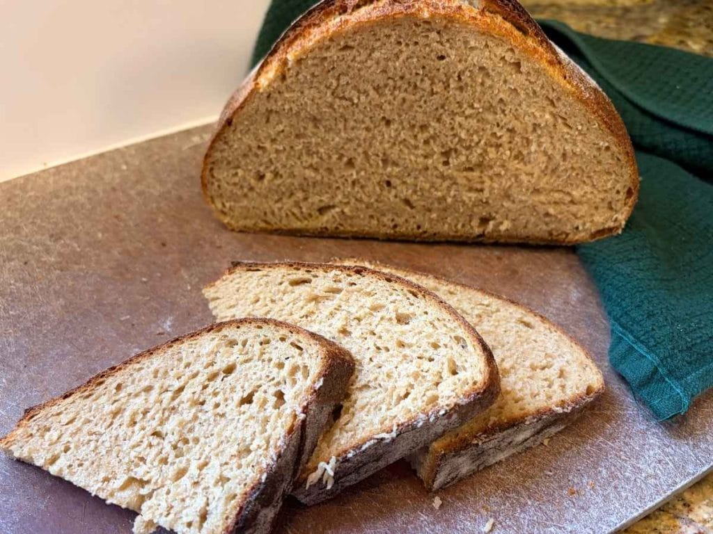 sliced up sourdough whey loaf on a cutting board