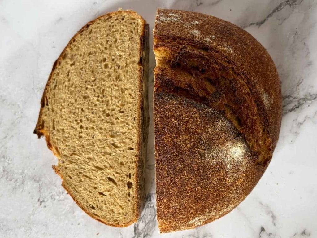 sourdough whey loaf cut in half with crumb visible