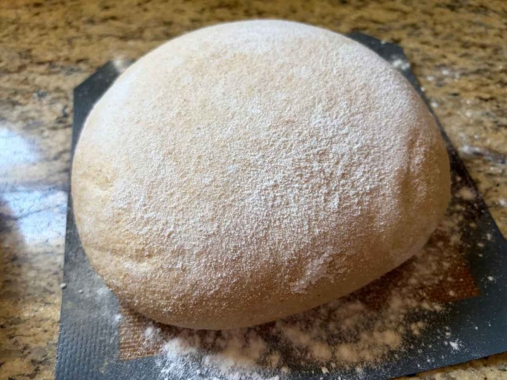 risen sourdough bread before baking on a silicone baking mat