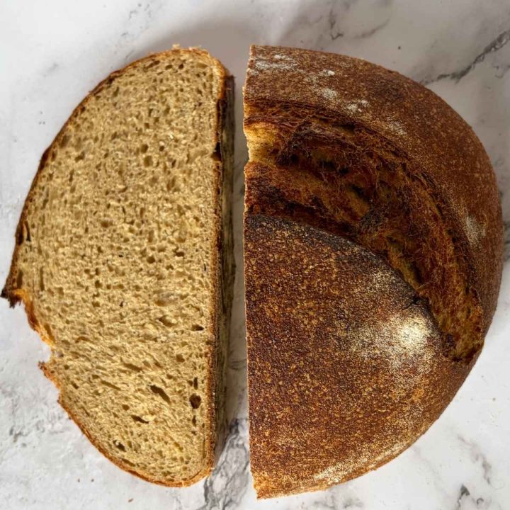 sourdough whey loaf cut in half with crumb visible