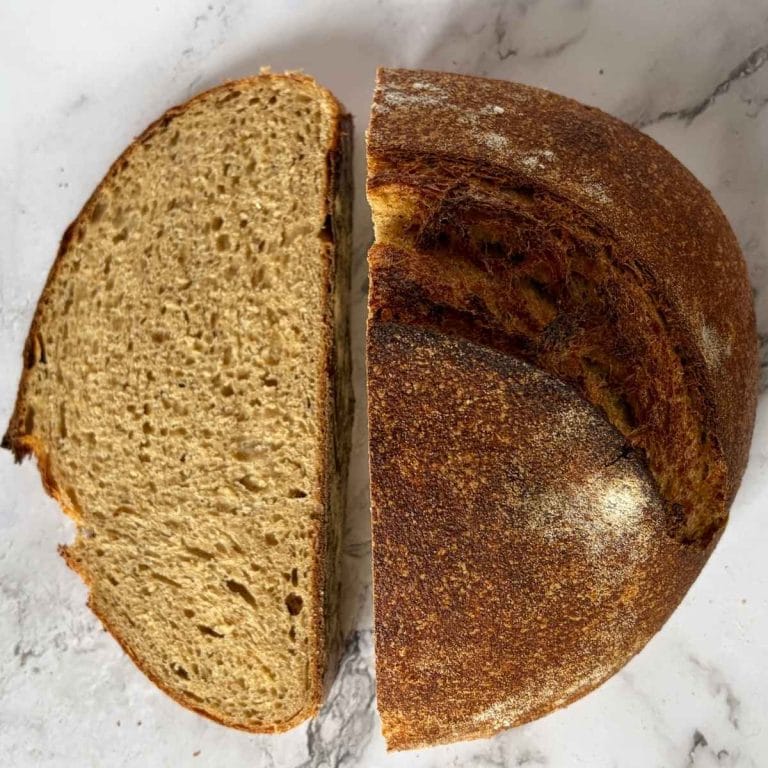 sourdough whey loaf cut in half with crumb visible