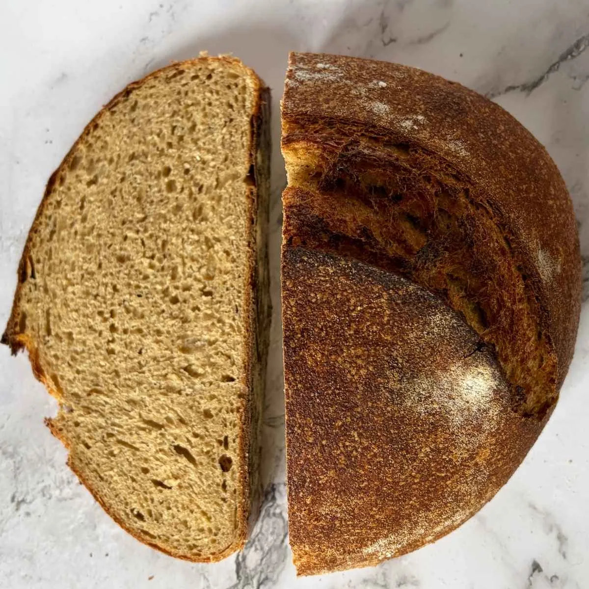 sourdough whey loaf cut in half with crumb visible