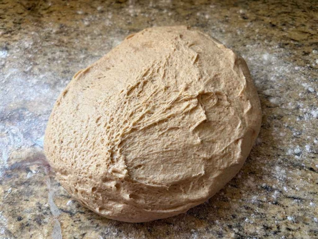 sourdough dough on a dusted surface before shaping
