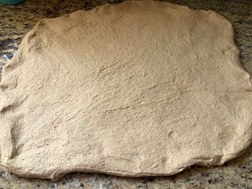 sourdough whey dough stretched out to laminate before shaping