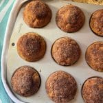 Pumpkin spice muffins baked in a muffin pan and topped with cinnamon sugar