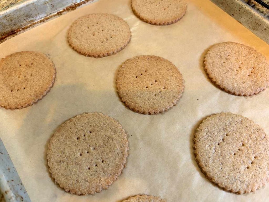 baked speculaas graham crackers on a parchment-lined baking sheet